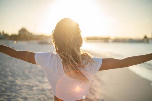 Woman enjoying the beach at sunset