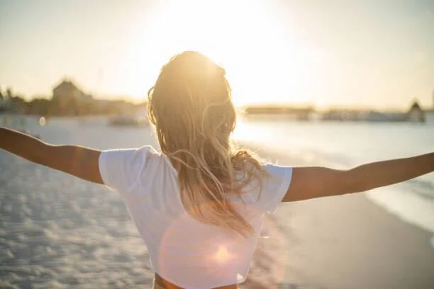 Woman enjoying the beach at sunset