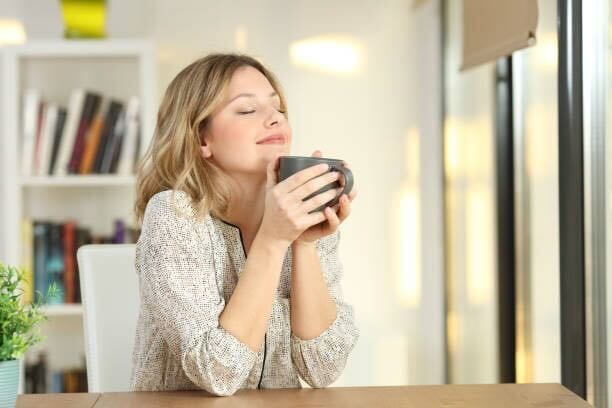 Woman relaxing and enjoying a cup of coffee