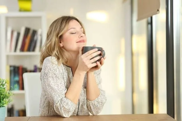 Woman relaxing and enjoying a cup of coffee