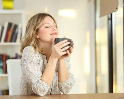 Woman relaxing and enjoying a cup of coffee