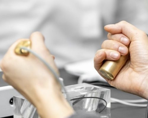 hands holding BioEnergetic Scan Equipment