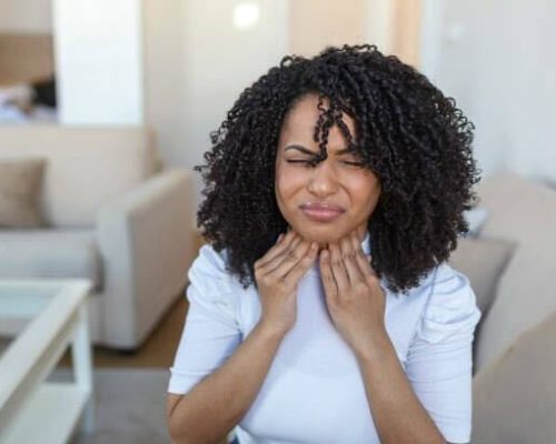 Woman touching her neck.
