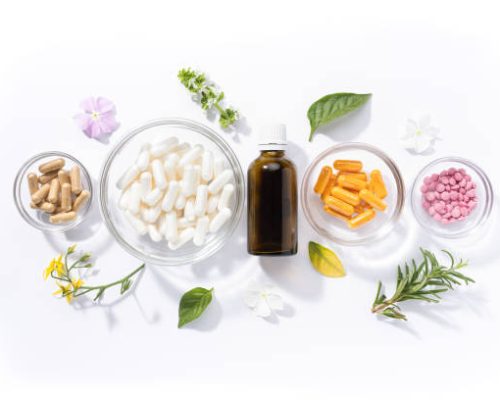 Flat lay composition of various vitamin capsules and dietary supplements isolated on white background. Vitamin complexes concept.