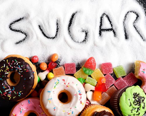 mix of sweet cakes, donuts and candy with sugar spread
